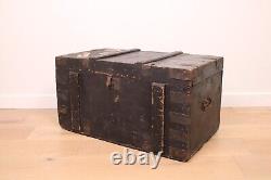 A vintage black wooden trunk with hinged lid blanket box log storage