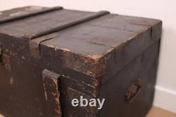 A vintage black wooden trunk with hinged lid blanket box log storage