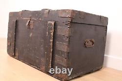 A vintage black wooden trunk with hinged lid blanket box log storage