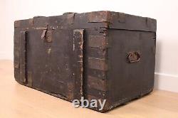 A vintage black wooden trunk with hinged lid blanket box log storage